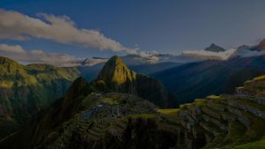 Machu Picchu Valley with the Sun Flowing down from Right to Left with a dark overlay over image